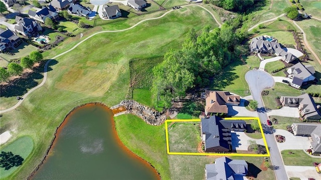 drone / aerial view with a water view, a residential view, and golf course view