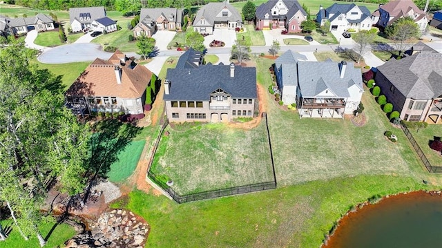 drone / aerial view with a residential view and a water view