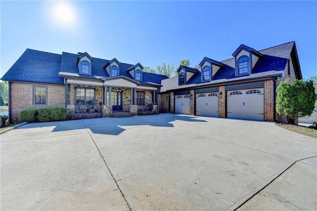 view of front of property featuring brick siding and concrete driveway