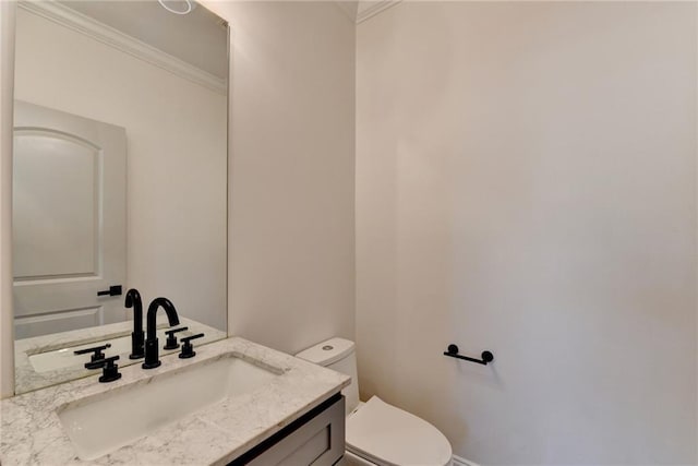 half bath featuring toilet, ornamental molding, and vanity