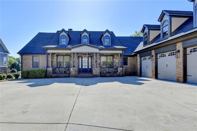 view of front facade featuring concrete driveway, brick siding, and a garage