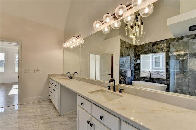 full bath featuring double vanity, baseboards, a shower stall, and a sink