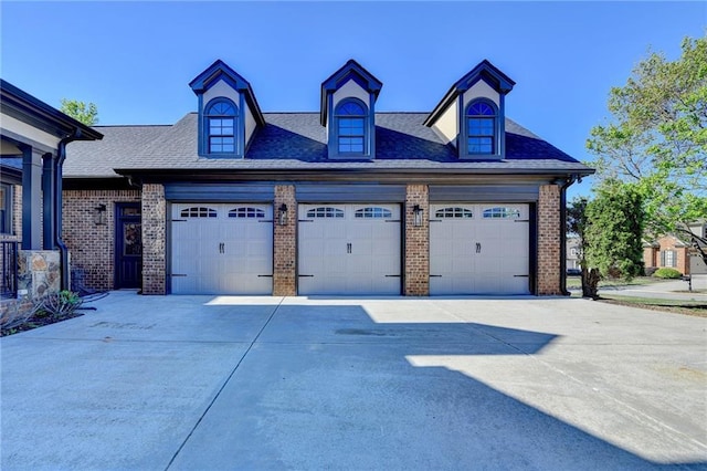 garage featuring concrete driveway