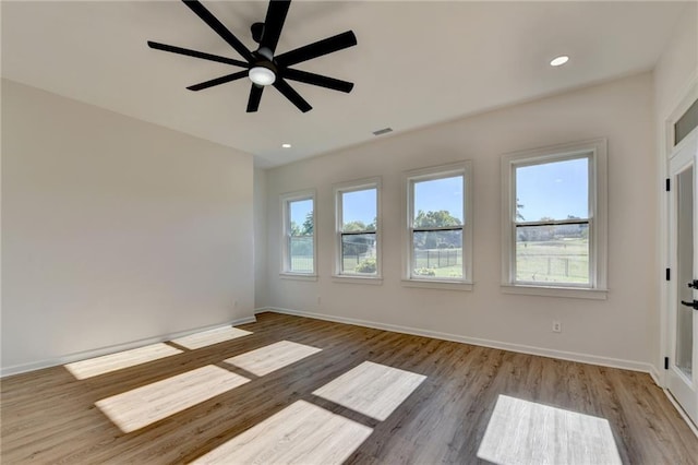 unfurnished room featuring baseboards and a wealth of natural light