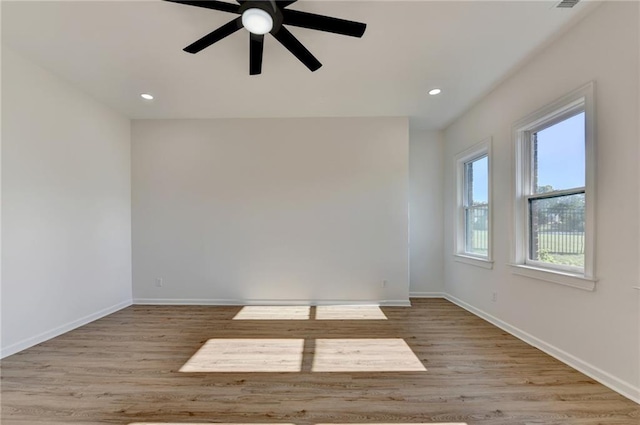 spare room with a ceiling fan, baseboards, recessed lighting, and wood finished floors