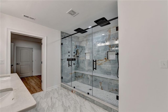 full bath featuring baseboards, marble finish floor, a marble finish shower, and visible vents