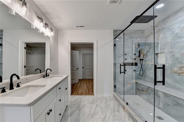 bathroom featuring visible vents, a marble finish shower, a sink, and marble finish floor