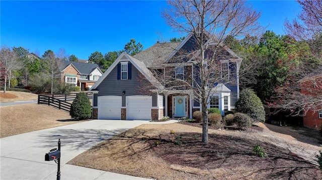 view of front of house featuring driveway, a garage, and fence