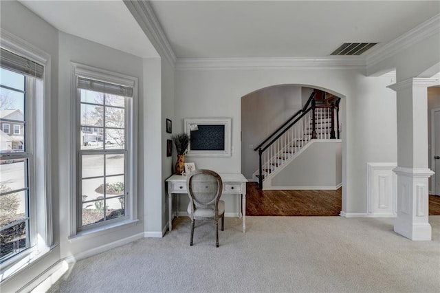 carpeted office featuring crown molding, arched walkways, visible vents, and baseboards