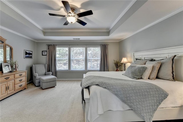 bedroom with ceiling fan, a raised ceiling, ornamental molding, and light carpet