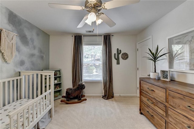 bedroom with ceiling fan, light colored carpet, visible vents, and baseboards