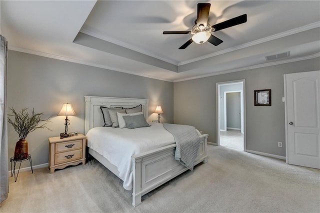 bedroom with light colored carpet, baseboards, a tray ceiling, and ornamental molding