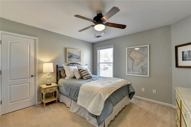 bedroom with a ceiling fan, visible vents, light colored carpet, and baseboards