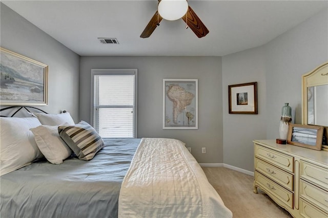 bedroom featuring visible vents, baseboards, light colored carpet, and ceiling fan