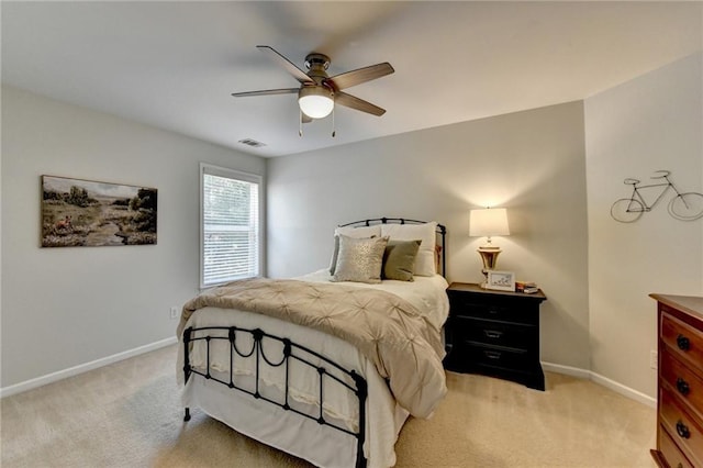 bedroom with light carpet, visible vents, a ceiling fan, and baseboards