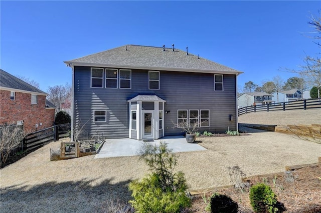 rear view of property featuring a patio and a fenced backyard