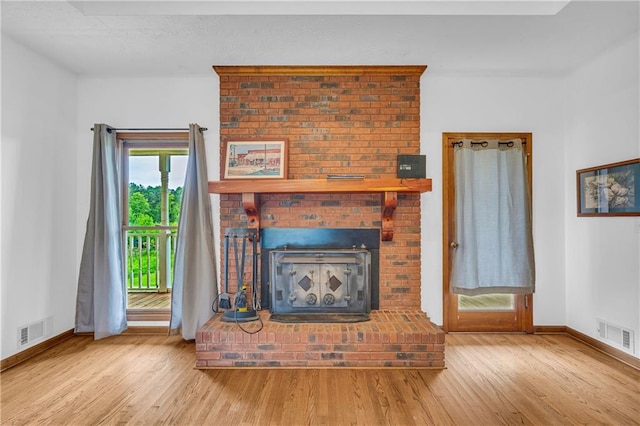 unfurnished living room featuring light wood-type flooring, baseboards, and visible vents