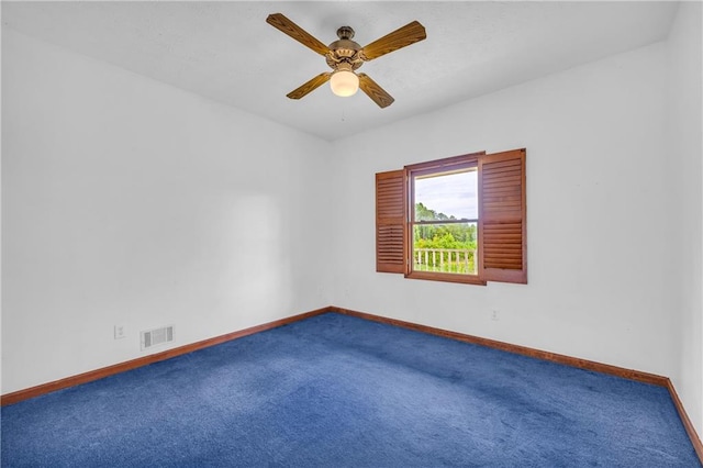 spare room featuring carpet flooring, baseboards, a ceiling fan, and visible vents