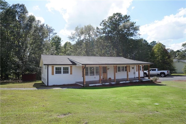 ranch-style house featuring covered porch and a front yard