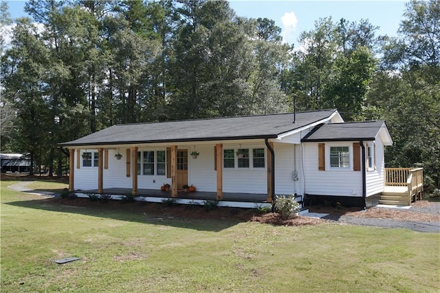 ranch-style home featuring covered porch and a front lawn