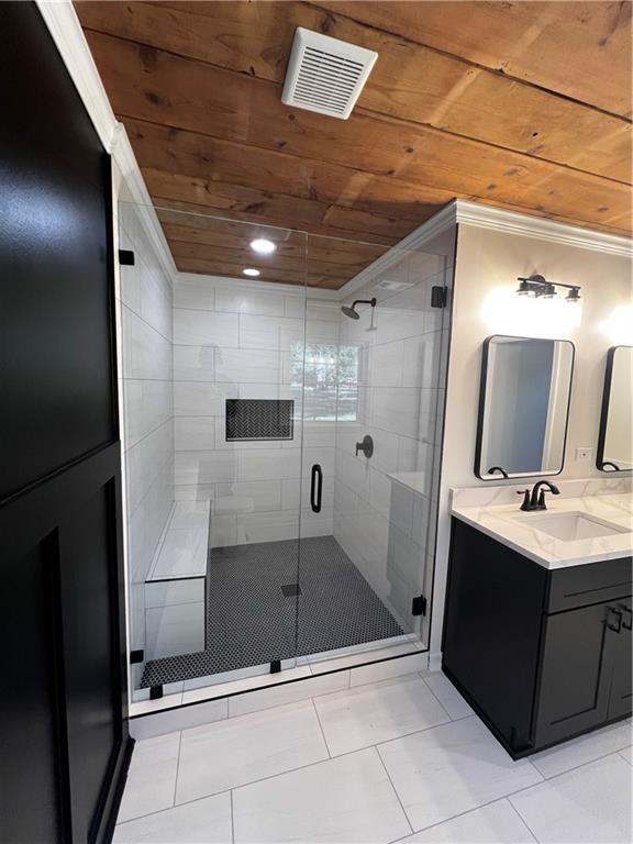 bathroom featuring vanity, tile patterned floors, crown molding, walk in shower, and wood ceiling