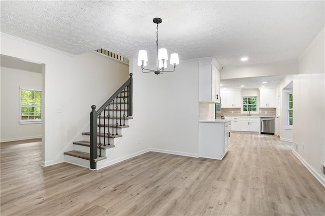 3021 Mills Ridge Dr, Canton, GA 30114 - kitchen featuring dishwasher, light wood-type flooring, light countertops, white cabinets, and a textured ceiling