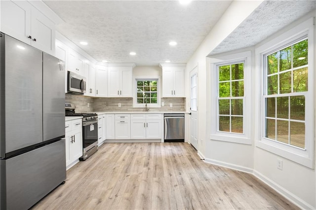 3021 Mills Ridge Dr, Canton, GA 30114 - kitchen featuring appliances with stainless steel finishes, tasteful backsplash, white cabinets, light countertops, and recessed lighting
