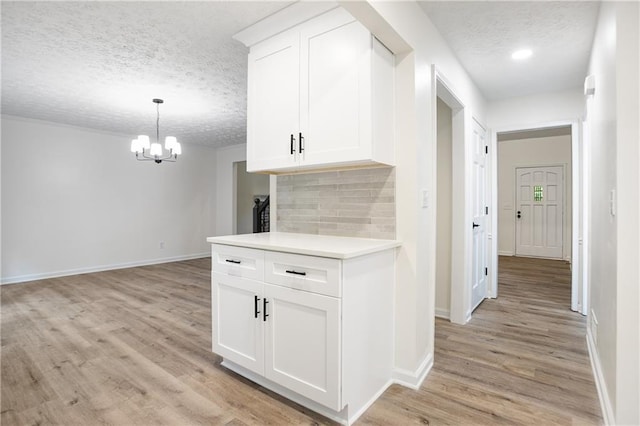 3021 Mills Ridge Dr, Canton, GA 30114 - hall with a textured ceiling, a chandelier, light wood-style flooring, and baseboards
