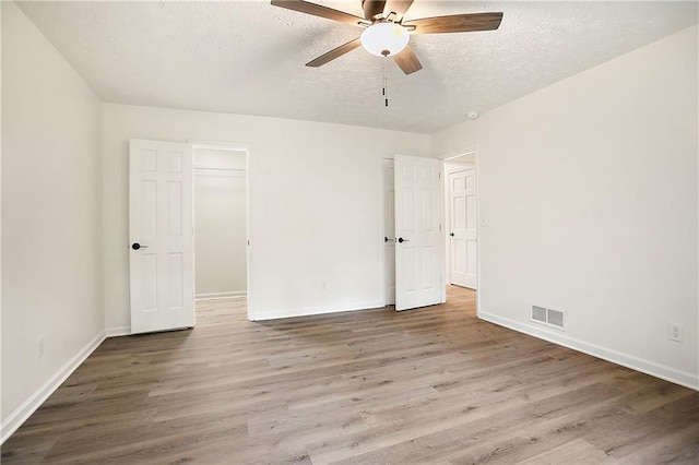 3021 Mills Ridge Dr, Canton, GA 30114 - unfurnished bedroom featuring wood finished floors, baseboards, a textured ceiling, and ceiling fan