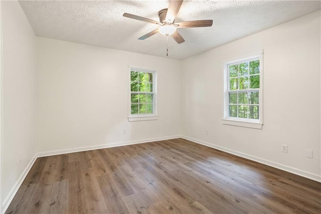3021 Mills Ridge Dr, Canton, GA 30114 - spare room featuring plenty of natural light, wood finished floors, ceiling fan, and a textured ceiling