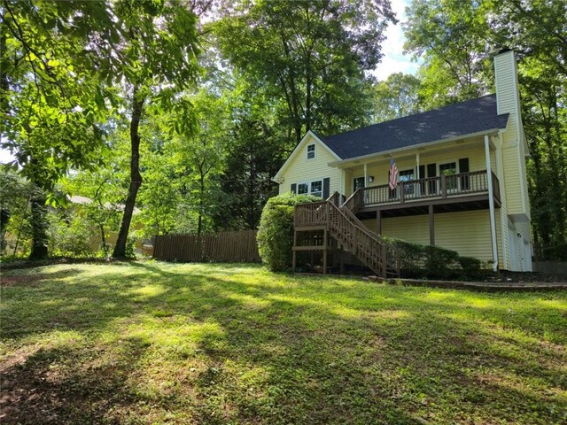 3021 Mills Ridge Dr, Canton, GA 30114 - back of property featuring a chimney, stairway, and a wooden deck