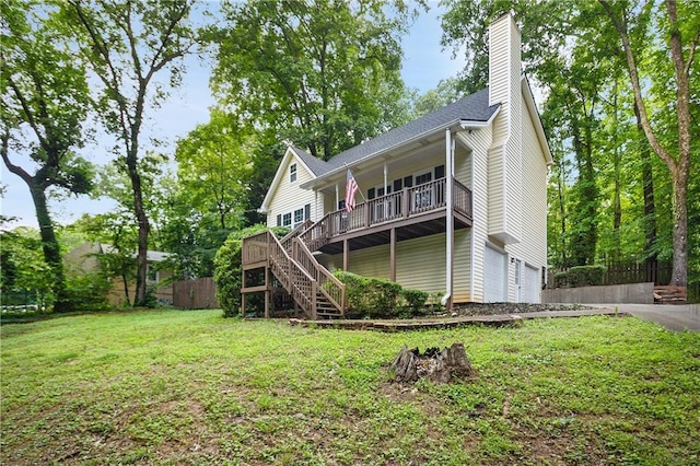 3021 Mills Ridge Dr, Canton, GA 30114 - back of property with stairway, a garage, a chimney, driveway, and a deck