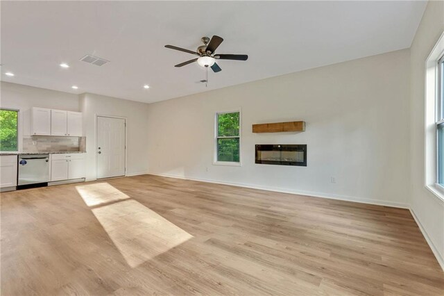70 Wheeler Lake Path, Dallas, GA 30157 - unfurnished living room with light wood-type flooring, recessed lighting, a glass covered fireplace, ceiling fan, and baseboards