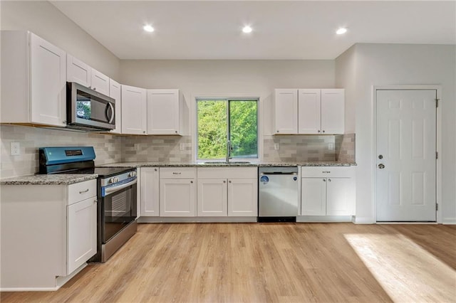 70 Wheeler Lake Path, Dallas, GA 30157 - kitchen featuring stainless steel appliances, a sink, light wood-style flooring, white cabinets, and recessed lighting