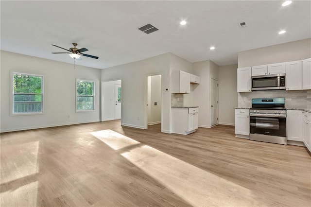 70 Wheeler Lake Path, Dallas, GA 30157 - kitchen with stainless steel appliances, open floor plan, ceiling fan, white cabinets, and backsplash