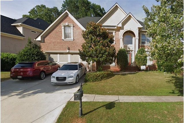 view of front of property with a garage and a front lawn