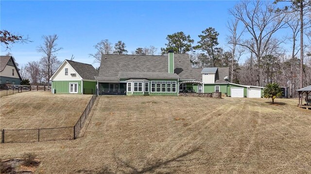 150 Crestview Rd, Jackson, GA 30233 - view of front facade with driveway, an outdoor structure, a sunroom, a garage, and a shingled roof