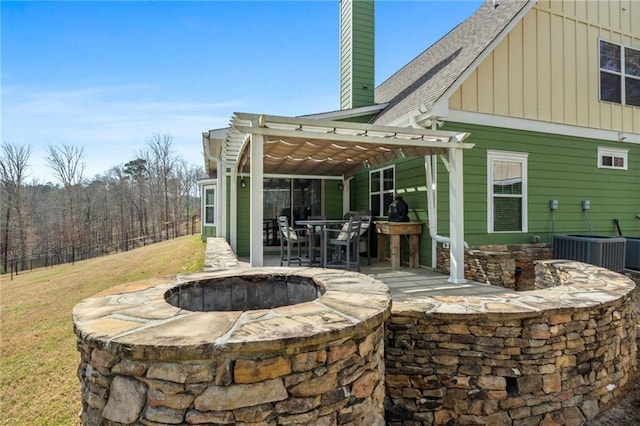 150 Crestview Rd, Jackson, GA 30233 - rear view of property featuring a fire pit, board and batten siding, a pergola, a chimney, and a patio area
