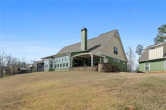 150 Crestview Rd, Jackson, GA 30233 - rear view of property with a sunroom, board and batten siding, a lawn, a chimney, and an attached garage