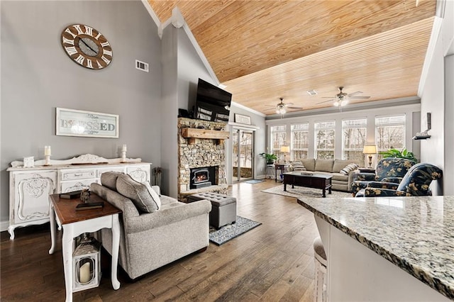 150 Crestview Rd, Jackson, GA 30233 - living room featuring wood ceiling, crown molding, ceiling fan, dark wood-style floors, and a stone fireplace