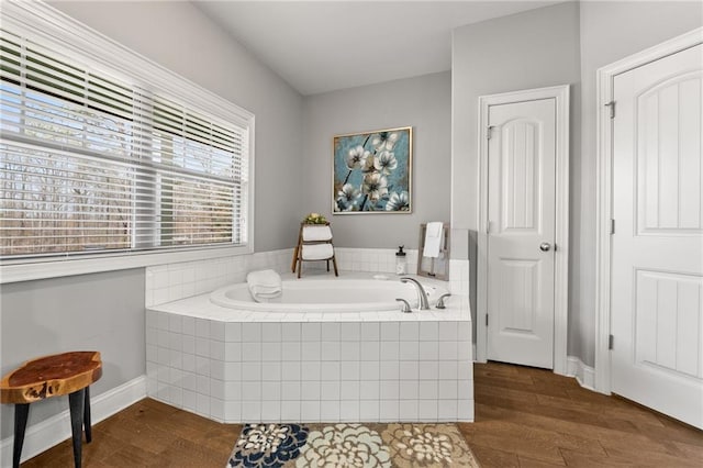 150 Crestview Rd, Jackson, GA 30233 - bathroom with a bath, wood finished floors, and baseboards