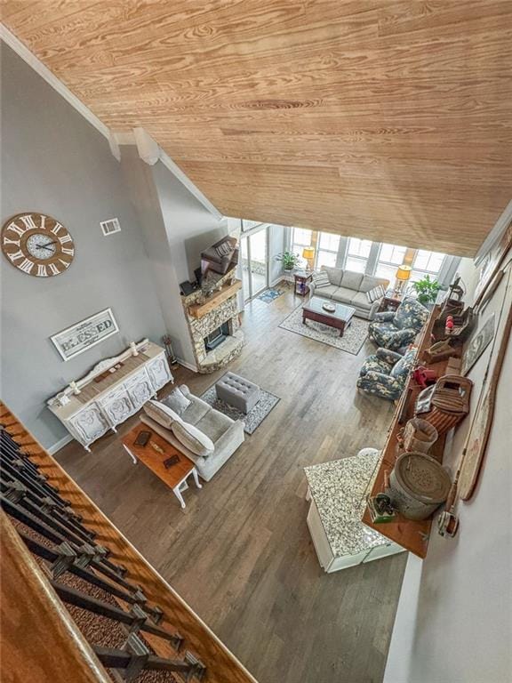 150 Crestview Rd, Jackson, GA 30233 - living area with wooden ceiling, wood finished floors, healthy amount of natural light, crown molding, and a stone fireplace