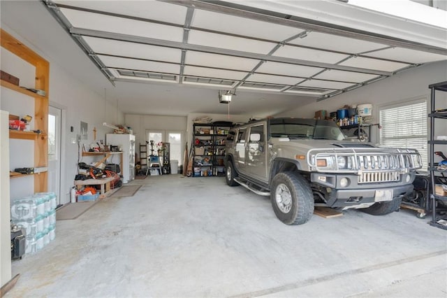 150 Crestview Rd, Jackson, GA 30233 - garage with a garage door opener and freestanding refrigerator