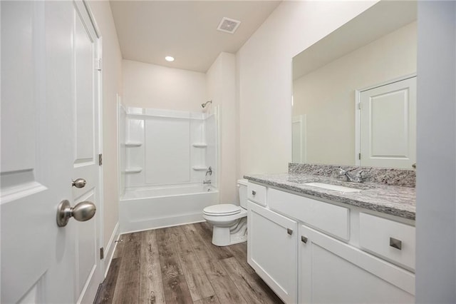 full bathroom with vanity, wood-type flooring, toilet, and shower / bathtub combination