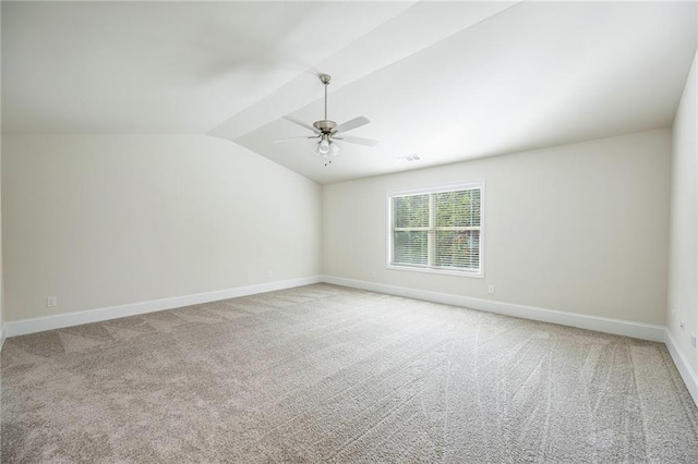 carpeted spare room with lofted ceiling and ceiling fan