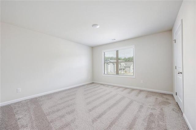 unfurnished room with light colored carpet