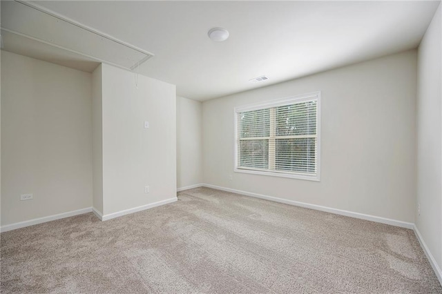 spare room with light colored carpet