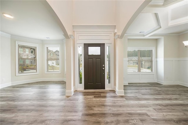 entrance foyer featuring ornamental molding, coffered ceiling, and wood-type flooring