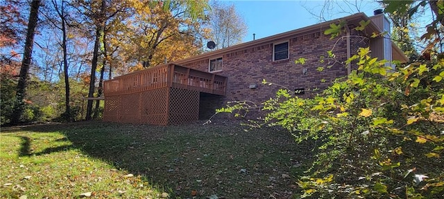 rear view of house with a lawn and a wooden deck