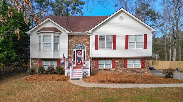 bi-level home with a front lawn